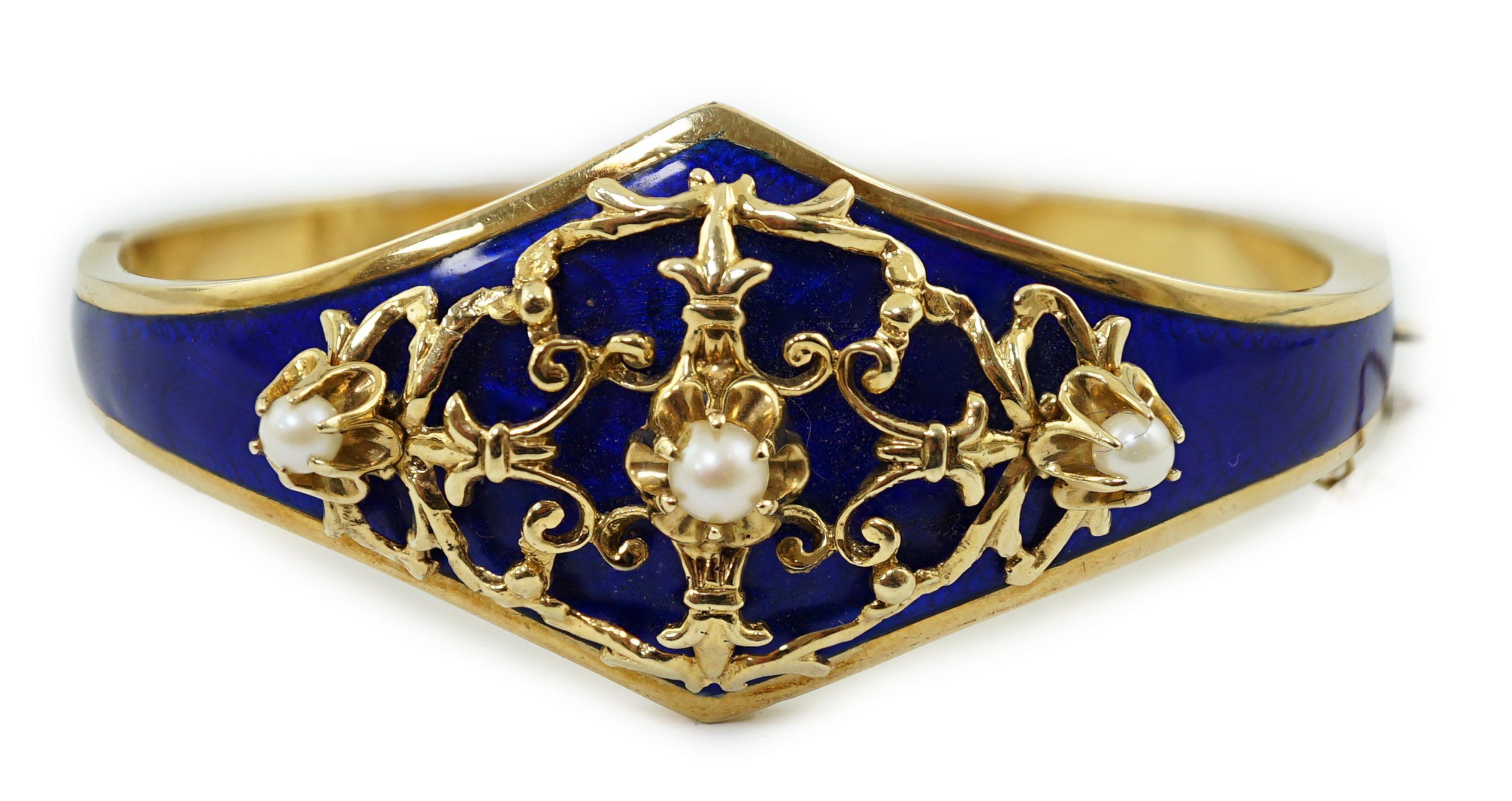 A continental Victorian style 14k gold, blue guilloche enamel and three stone cultured pearl set hinged bangle